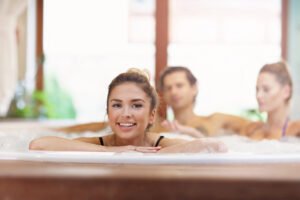 three people in hot tub