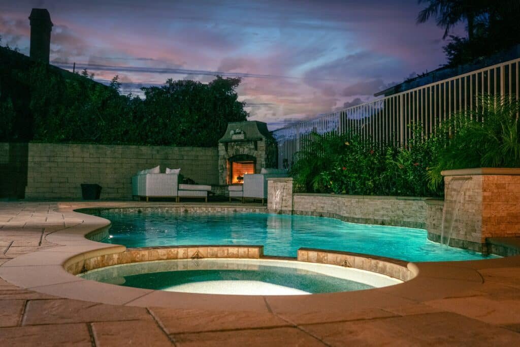 Backyard inground fiberglass pool with clear blue water